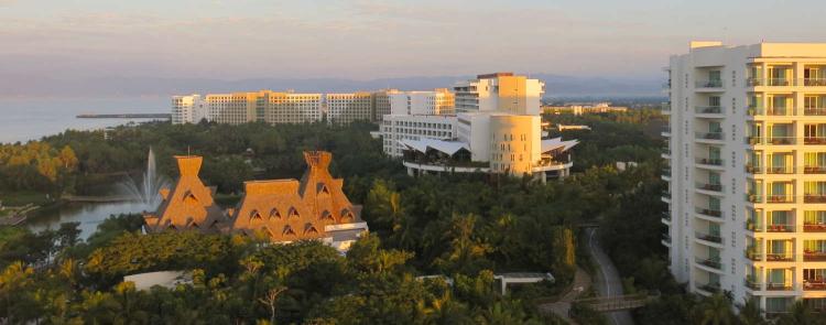 This photo shows the Grand Mayan tower, the Grand Bliss Tower, the Mayan Palace Tower and Luxxe Tower 2 at Grupo Vidanta's Nuevo Vallarta property in the state of Nayarit, Mexico.  The structure with the thatched roof is Cafe del Lago, a favorite breakfast restaurant on the property.