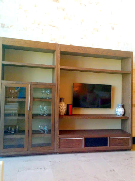 The wall unit in the living area contains a flatscreen TV and additional storage space.